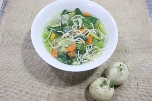 Lemon and coriander soup with steamed Buns and noodles