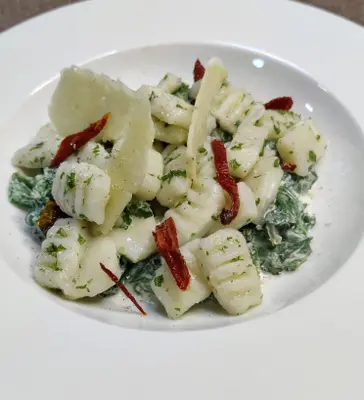 Gnocchi with sauteed spinach, oven roasted tomatoes and nutmeg